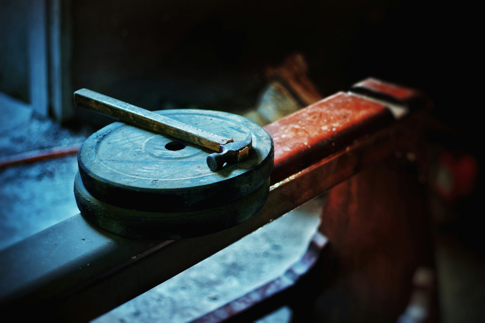 black round metal tool on brown wooden table